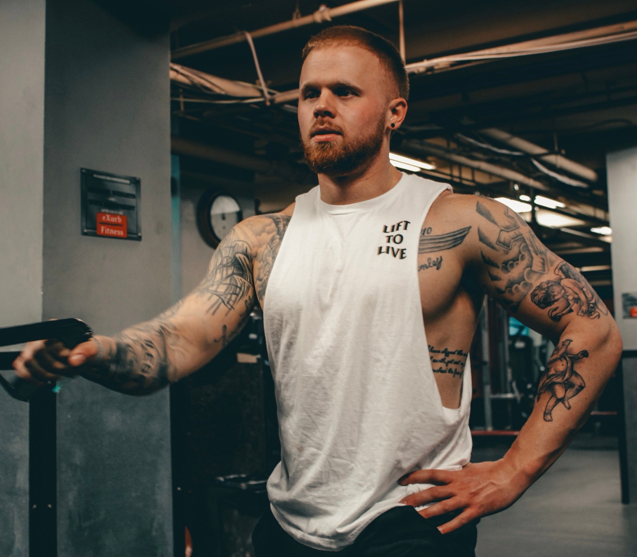 Lift To Live member training in the gym, wearing a Lift To Live tank